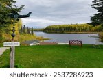 View of the Floatplane office wooden sign and beautiful lakes near Talkeetna in autumn colors, Alaska, USA