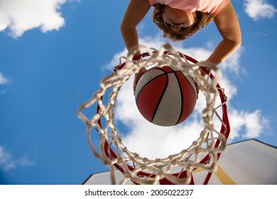 View Of Flying Ball To Basket From Top, Kid Play Basketball. Little Child Boy Playing Basketball With Basket Ball. Active Kids Lifestyle.