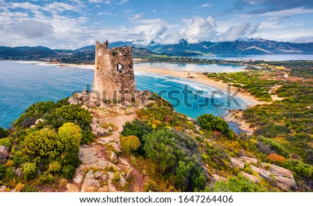 View from flying drone. Colroful spring view of Torre di Porto Giunco tower on Carbonara cape. Fantastic morning scene of Sardinia island, Italy, Europe. Colorful Mediterranean seascape.