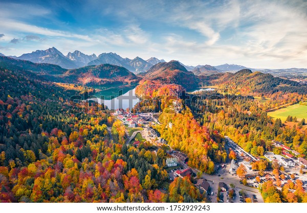 View\
from flying drone. Gorgeous autumn scene of Hohenschwangau Castle,\
new Gothic style castle, summer residence of King Ludwig II.\
Breathtaking morning scene of Alpsee lake, Germany.\
