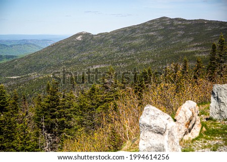 View of forest, mountains, rocks road from the top of Whiteface Mountain in sunny day in the State New York USA, Summer 2021, 