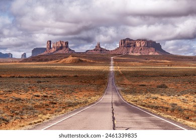 View of Forrest Gump Scenic road in Monument Valley, Utah during a cloudy day shows the long, lonely road moving into Arizona through the famous mountain range shown in the movie. - Powered by Shutterstock