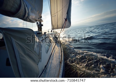 View forward from a sailboat tilted by the wind