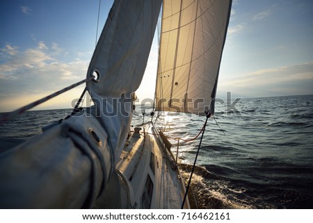 View forward from a sailboat tilted by the wind