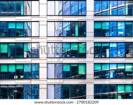 A view of the front facade of the office building with regular pattern of rectangular windows.