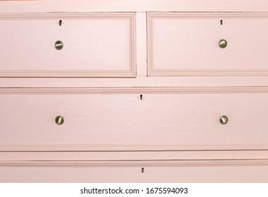 View Of Front Side Of An Old Pink Chest Of Drawers. Close-up.