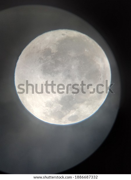 The
view of full bright moon surface from the
telescope