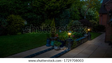 A view of garden lights on a brick wall in Market Harborough, UK at night