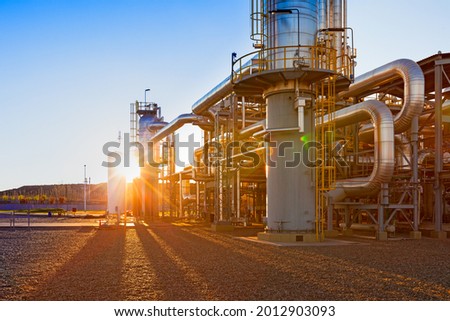 View of a gas refinery plant illuminated at sunset