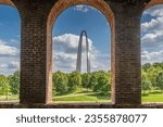 A view of the Gateway Arch in St Louis through opening of brick wall at train station