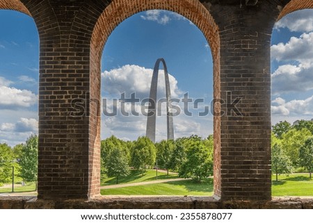 A view of the Gateway Arch in St Louis through opening of brick wall at train station