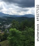View of Gatlinburg with clouds and mountains in background in Gatlinburg, TN- June 5, 2015