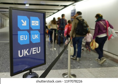 View Of A Generic UK/EU Lane Sign As Air Travellers Proceed To Passport Control At A British Airport 
