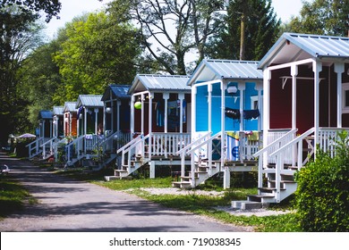 View of german camping place with tents, caravans, trailer park and cabin cottage houses - Shutterstock ID 719038345