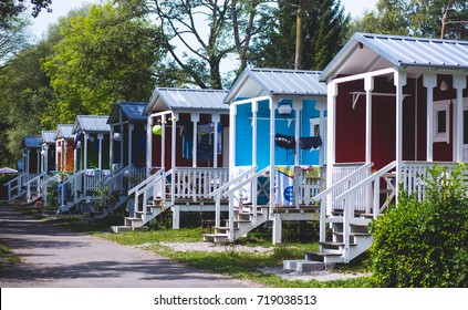 View of german camping place with tents, caravans, trailer park and cabin cottage houses