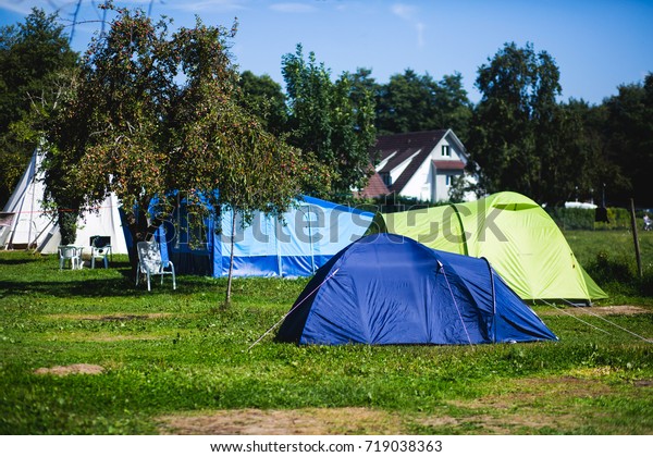 View of german camping place with
tents, caravans, trailer park and cabin cottage
houses