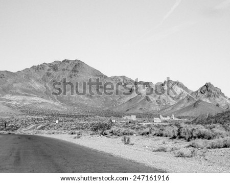 View of the ghost town of Rhyolite in Death Valley Nevada USA with ruins of the old bank, school and railway station in black and white