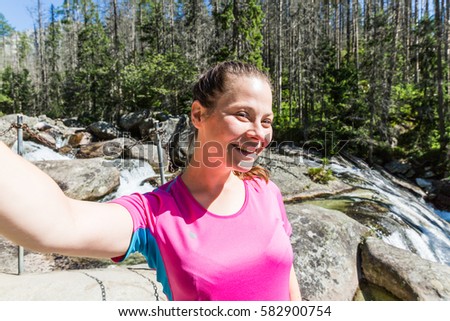 View of a girl hiking to the Teryho Chata in the Slovakian mountains High Tatra in summer 2016