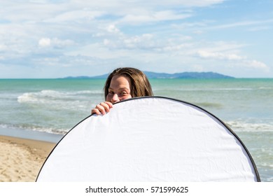 View Of A Girl Holding A Photo Reflector At The Beach