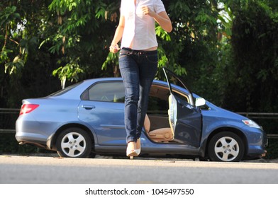 View Of A Girl Running Away From A Blue Car