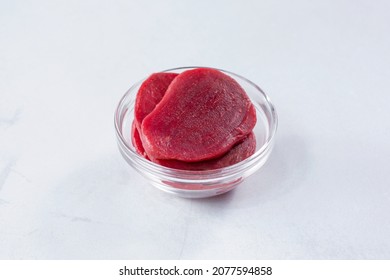 A view of a glass cup of sliced beets.