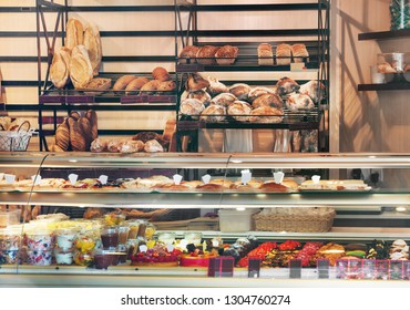 View of glass display full of various appetizing confectioneries in pastry shop in France