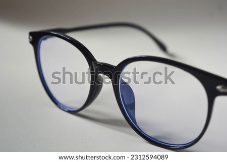 View of glasses with black frames, white background.