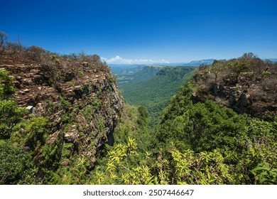 View from God's Window viewpoint with Aloe flowers foreground in Blyde River Canyon Nature Reserve, along the Panorama Route in Mpumalanga, South Africa - Powered by Shutterstock