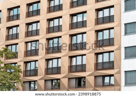 View of the golden building facade with balconies, large balcony windows, traditional European modernist residential buildings Golden facade windows, Residential architecture, European modernist style