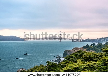 View of Golden Gate Bridge, in the evening. Photo taken from Lands End trial. Lands End is a park in San Francisco, CA within the Golden Gate National Recreation Area.