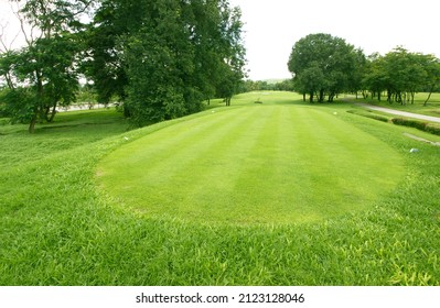 View Of Golf Course With Beautiful Putting Green. Golf Course With A Rich Green Turf Beautiful Scenery.
