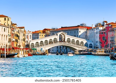 View of Grand Canal with Rialto Bridge and gondoliers in Venice, Italy. Landscape with  Rialto Bridge and gondola on the Grand Canal in Venice, Italy, Europe.  - Powered by Shutterstock