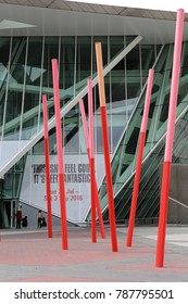 View Of The Grand Canal Theater Of Dublin Ireland Also Called The Bord Gáis Energy Theatre. Red Fine Columns Are Placed In The Ground Of The Place. The Picture Has Been Taken On 6th August 2016.