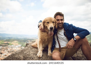 The view is great from up here. Cropped portrait of a handsome young man and his dog taking a break during a hike in the mountains. - Powered by Shutterstock