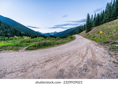 View of green alpine mountains with dirt country rural countryside road to Ophir pass by Columbine lake trail in Silverton, Colorado in summer morning - Powered by Shutterstock