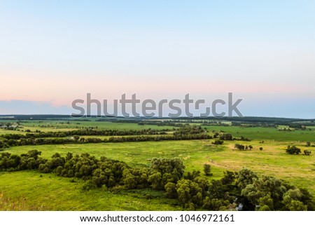 View of green forest-steppe plain. Flatland valley in evening time. Belgorod region, Russia.