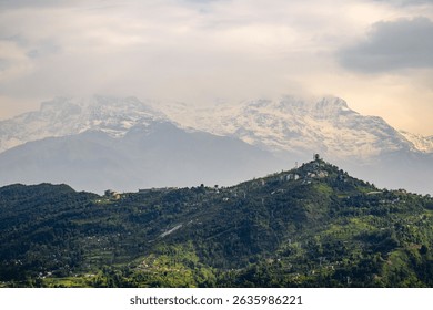The view of green hills and the Annapurna mountain range in the background. Pokhara, Nepal.