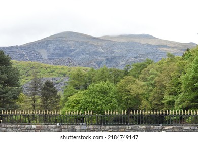 View Of The Green Mountains At Snowdonia National Park And The Forest Trees On A Spring Day With Clouds In The Sky