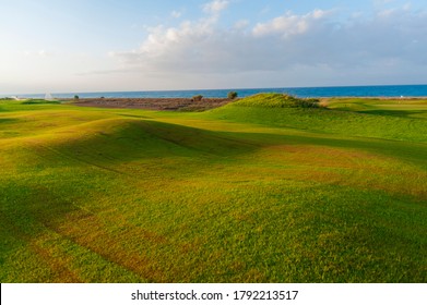 View of green rolling landscape and irrigation or sand traps on the golf course - Powered by Shutterstock