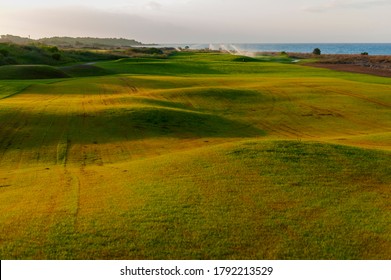 View of green rolling landscape and irrigation or sand traps on the golf course - Powered by Shutterstock