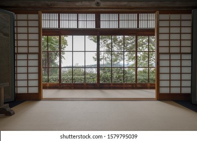 View of green trees and Kyoto from a window in a traditional room with shoji dividers and tatami in Honen-in temple - Shutterstock ID 1579795039