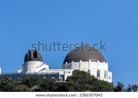 a view of the griffith observatory from a nearby hill, image shows the los angeles observatory built in 1933 on a clear sunny day and open to the public, taken october 2023