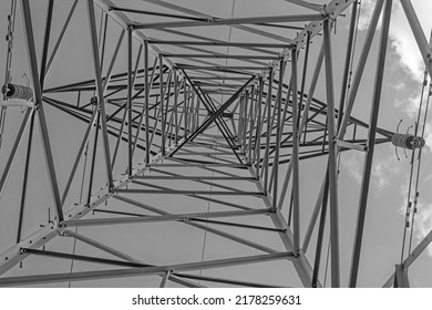 The View From The Ground, Looking To The Top Of A High Voltage  Electricity Pylon.  The Structure Is Designed To Transfer Power With Attention Paid To Safety Features.