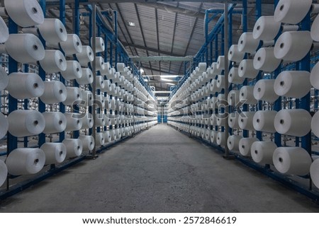 View group of bobbin thread cones on a warping machine in a textile mill. Yarn ball making in a textile factory. 