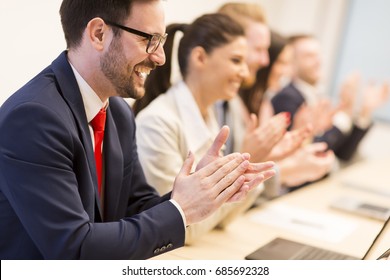 View At Group Of Business People Clapping Their Hands At The Meeting