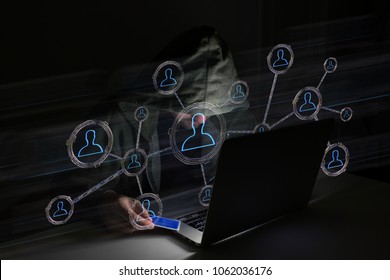 View of a Hacker man in the dark using computer to hack data and information system