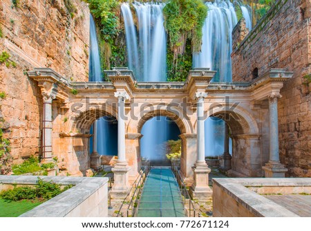 View of Hadrian's Gate in old city of Antalya with duden waterfall - Antalya, Turkey