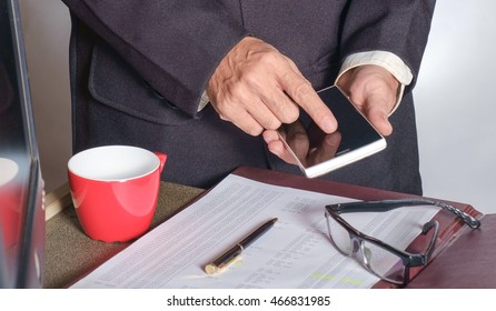 View of hand of business man holding smartphone in the office. - Shutterstock ID 466831985