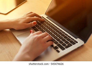 view of the hands of a woman working on the computer in the morning