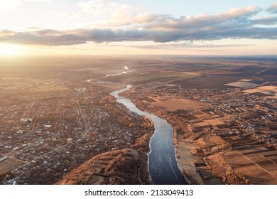 View From A Height Of A Blue Winding River Stretching Into The Distance. Autumn Landscape At Sunset